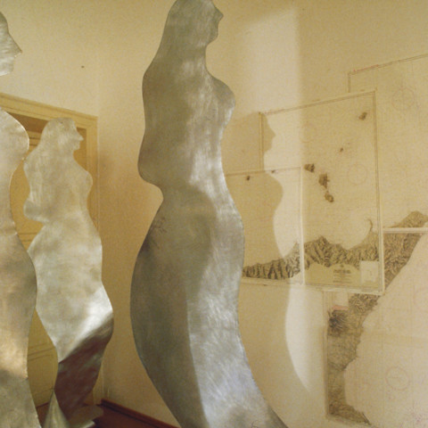 Sirene - Reflux (2001). Sagome di zinco sabbiato appese con un amo d’acciaio, fili di nylon, carte nautiche, luce artificiale (dimensioni variabili). Ph. Sandro Scalia.